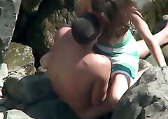 Beach Voyeur. Horny teen chick rides her boyfriend on the beach