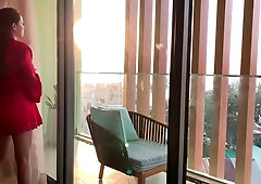 Voluptuous brunette Vina Moon pleasures her redheaded lover on the balcony at sunset