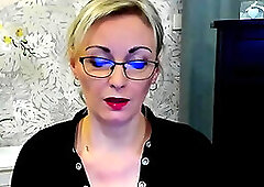 Busty German amateur blonde MILF LUXvanessa in orange mini skirt and black blouse with a big cleavage posing on webcam for fans on solo webcam show