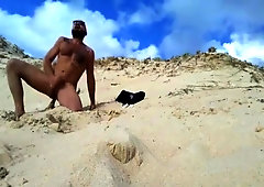 Bearded stud fucks himself on beach