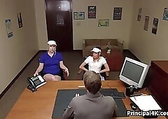 Head teacher blown by two by his desk