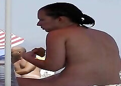 See those smooth nudists play at a public beach