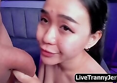 T-girl showers her load all over the face of an Asian beauty.
