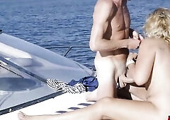Excited golden-haired big beautiful woman cougar George Porno screwing a big dong on a boat outdoors