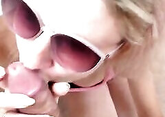 Stranger with glasses, on the balcony, sucks a large cock and gets a large ejaculation on her face and glasses