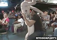 Male stripper with tattoos having fun at a party