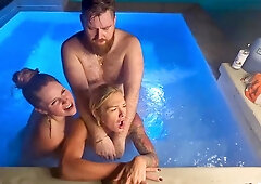 Bubbly girlfriends splashing in hot tub threesome kissing passionately under stars