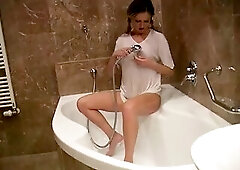 Breasty golden-haired wearing shirt during the time that taking a shower.