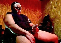 Buff guy in uniform giving himself a handjob with his massive cock