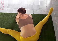 Regina Noir stretches in yellow leggings during a private yoga session at the gym