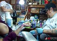 Blonde MILF teasing tits while getting fresh ink in cozy parlor