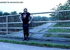 crossdressed outdoors on a motorway bridge