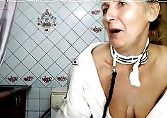 Pleased Lukerya out of hairstyle and makeup in the kitchen in a dressing gown tries on white handcuffs and a collar with a ebony leash, exposing nipps