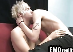 Passionate twinks kissing and undressing on a bed