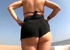 Stepmom flaunts with her big ass on the beach