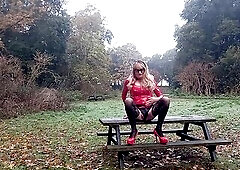 Aged crossdressing shemale whore outdoors in pvc, posing for the camera