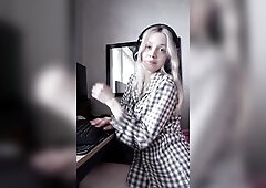 Blond leans back in her chair pulling her shirt up slow