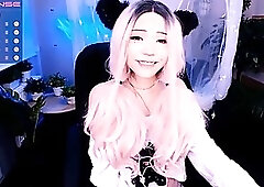 Adorable girl with long, pink hair is about to show us her tiny tits, just for fun