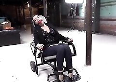 Gagged woman is about to get bound up and tortured in the basement, cuz this babe loves it