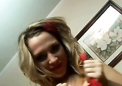 A curvy blond with a red hair bend undresses and works a glass toy into her snatch on a patterned sofa.