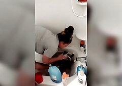 Charming gal gives kitten a washroom