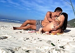 Steamy couple having fun on the public beach