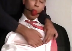 Suit bondage. Sexy dude bound & gagged by masked man