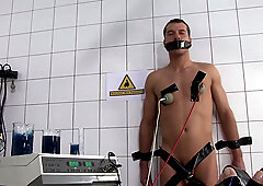 Waxed blonde slave with big tits and short hair gets her throat pounded by her master during a brutal BDSM session in the dungeon