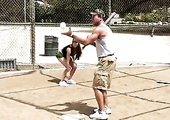 Trainer shows two female athletes how to properly handle a large bat