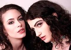 Cute-looking girls Anna De Ville and Lydia Black are sucking a huge dildo