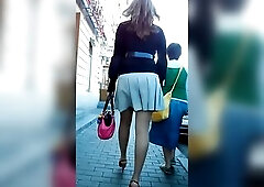 Unsuspecting tiny golden-haired teen in a cute ebony shirt and striped light blue petticoat walks down the street as the hidden livecam films upskirt 