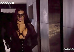 Gorgeous, black haired woman is wearing a lacy mask on her face while sucking a fat dick