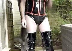 Pretty gay boi in latex smoking