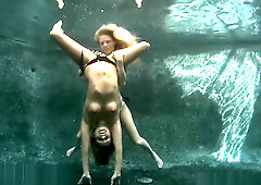 Blonde and redhead join a bearded man for an underwater threesome
