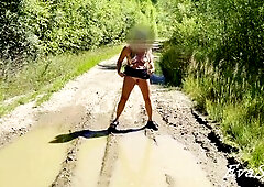 hot golden-haired pissing in a puddle on the road