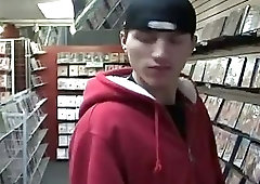 Dude sucking on a big gay dick at the video store gloryhole