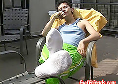 slim queer Rodrigo displays his hairy feet outdoors