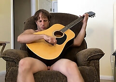 Bare Unshaved Dude Guitar Toying