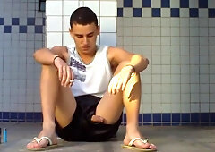 boy sitting in the douche flashes his huge knob
