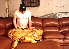 Close-up on guy getting off on a leather bed