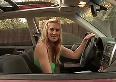 Two blonde lesbians share intimate moments outdoors on a gravel patch