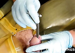 With his nuts tightly squeezed into a studded crusher, Madame Li Ying and I set to work teasing this rubber gimps penis, latex gloves edging him as we
