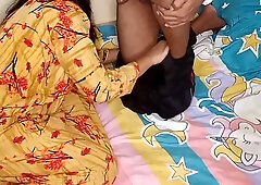 Indian wife in yellow floral dress takes her husband from behind in passionate bedroom encounter