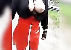 sissy floozy walks around and shows her large titties by the roadside