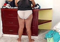 corpulent gal tidying the room and folding clothing
