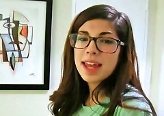 Ava Taylor wears her glasses while she plays with a cock