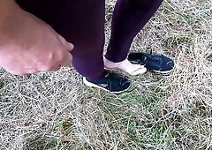 Woman dominated outdoors with whip and breast exposure on secluded path