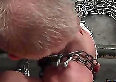 Naked twink is chained down by his wrists ankles and neck