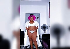 Black hawt big beautiful woman in white strap pants and brassiere
