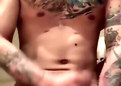 Hot Chinese tattooed boy is stroking a big cock